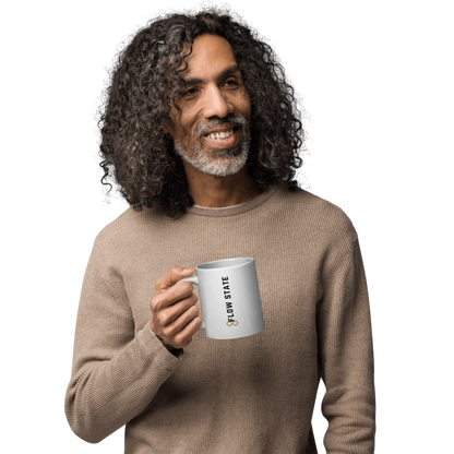 White ceramic coffee mug with vertical minimalist text and gold icon.