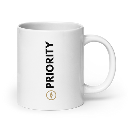 White 11 oz mug with blacktext and gold compass  on a white background