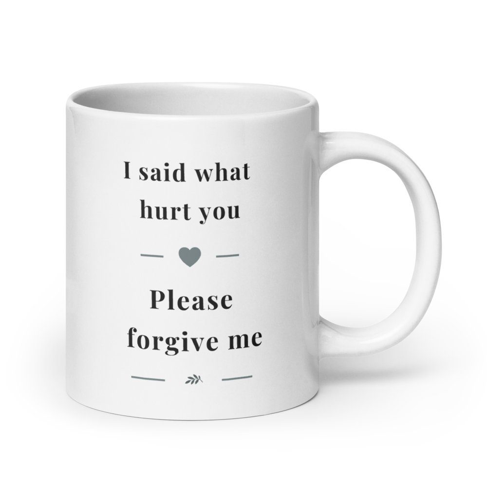 Side view of a white glossy ceramic mug with a comfortable C-handle, showing the "I said what hurt you" message in soft grey serif typography