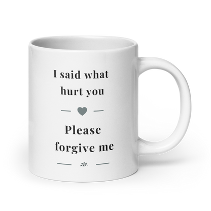 Side view of a white glossy ceramic mug with a comfortable C-handle, showing the "I said what hurt you" message in soft grey serif typography