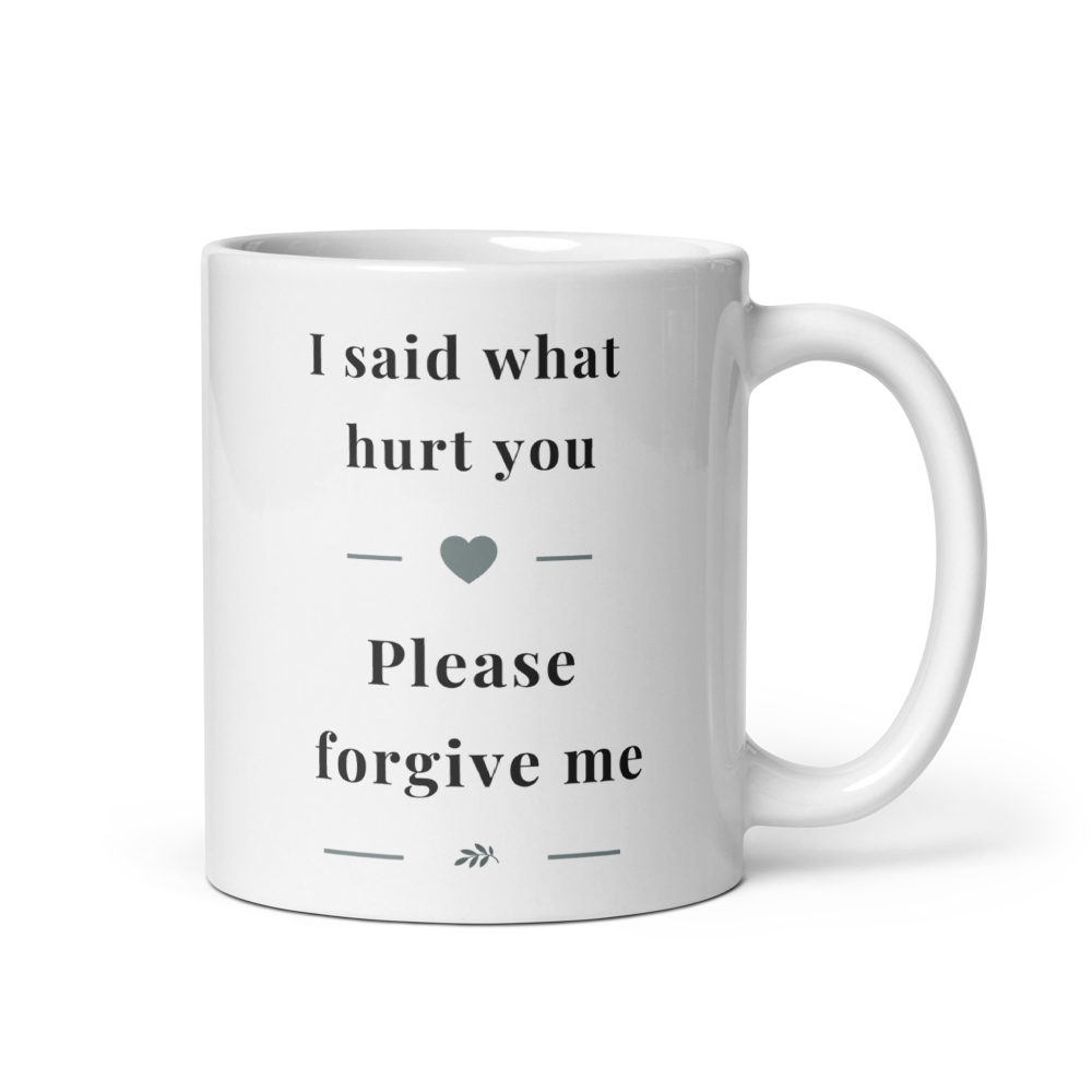 Side view of a white glossy ceramic mug with a comfortable C-handle, showing the "I said what hurt you" message in soft grey serif typography